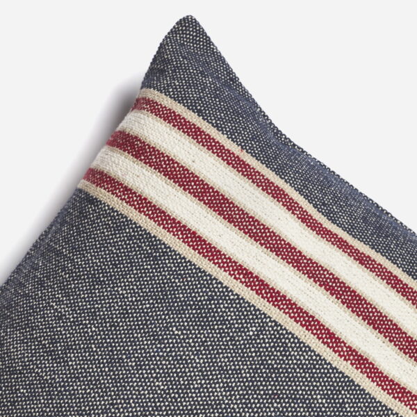 A thick cushion cover with navy and red stripes.